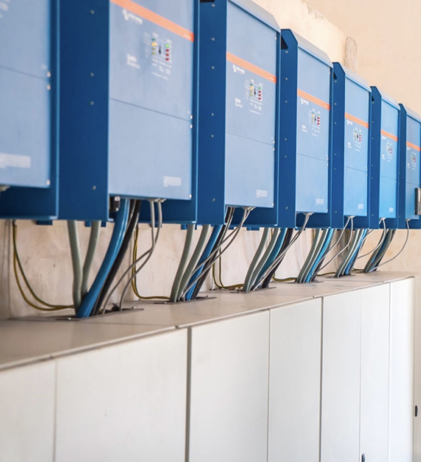 Row of Victron Quattro inverters installed at a remote site — scale job